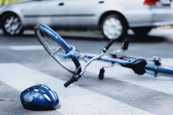 Helmet,And,Bike,Lying,On,The,Road,After,A,Car